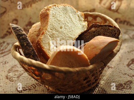 Un assortimento di pane affettato in un cesto di vimini vicino. Messa a fuoco selettiva. Foto Stock