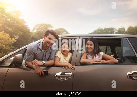 Famiglia a guardare fuori dalla finestra per auto Foto Stock