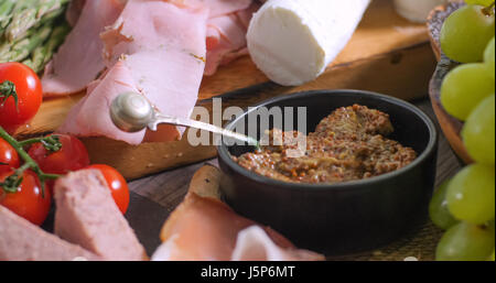 Dettaglio di un piatto di salumi (charcuterie), prosciutto, salame, paté e formaggio Foto Stock