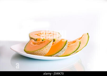 Piastra a fette di melone pezzi arancione Vitamine Vitamine dolcemente progenie frutti Foto Stock