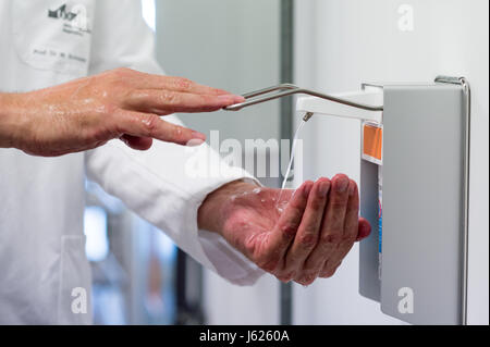 Regensburg, Germania. Decimo Apr, 2017. Un uomo si applica un disinfettante sulle sue mani presso la clinica universitaria di Regensburg, Germania, 10 aprile 2017. Schneider è la Baviera il primo professore di igiene ospedaliera. Presso la clinica dell'Università di Regensburg egli fornisce una formazione avanzata per i medici e il personale medico, consigli cliniche in Baviera orientale e ricerche organismi multiresistenti. Foto: Armin Weigel/dpa/Alamy Live News Foto Stock