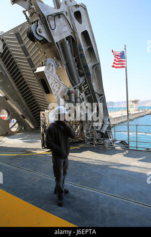 Morris Williams, USNS Trenton primo tecnico, ascolta per un aggiornamento sui problemi di manutenzione in prossimità della rampa di carico. Trenton, uno di solo otto Expeditionary Fast navi da trasporto militari Sealift Command di inventario, ha recentemente completato un annuale di un bacino di carenaggio revisione a Marsiglia, Francia. Foto Stock