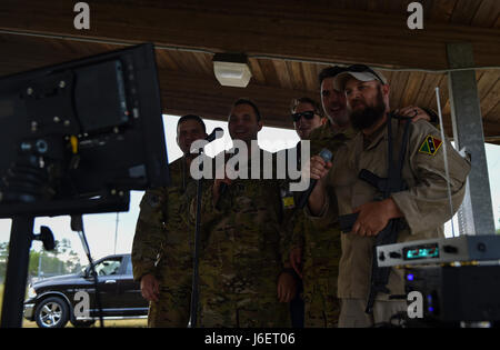 Aviazione di combattimento advisor gli studenti con il sesto Special Operations Squadron Canta karaoke con "Palmetto Terra" forze durante il funzionamento artiglio Raven al duca Campo, Fla., 26 aprile 2017. Gli studenti sono stati esposti a "Palmetto Terra" cultura che comprende aspirare gli occhi al di fuori di un testa di pesce, mangiare con le mani e cantare il karaoke. (U.S. Air Force foto di Airman 1. Classe Giuseppe Pick) Foto Stock