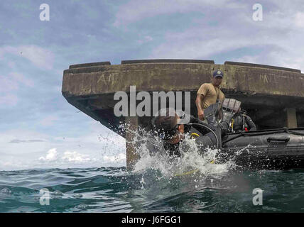 Stati Uniti Navy Utilitiesman 2a classe Erick Martin, costruzione subacquea Team 2, osserva Marina militare filippino Fireman seconda costruzione meccanico Arnel H. Perfinan, forze armate delle Filippine UCT, entrare in acqua durante un tuffo nel supporto di Balikatan 2017 a Ipil Porto di Ormoc City, Leyte, 15 maggio 2017. La formazione di immersione Prepara filippino e degli Stati Uniti i membri di servizio al fine di rimuovere i detriti nei porti e di aprire le linee di alimentazione per le vittime di catastrofi naturali e di crisi. Balikatan è un annuale U.S.-Philippine bilaterale di esercitazione militare incentrato su una varietà di missioni tra cui aiuti umanitari e disaster reli Foto Stock