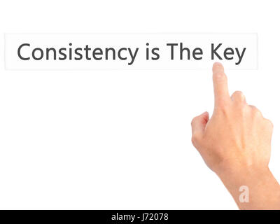 La coerenza è la chiave - Mano premendo un pulsante sul fondo sfocato concetto . Business, tecnologia internet concetto. Stock Photo Foto Stock