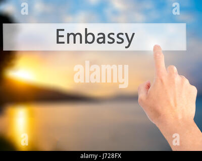 Embassy - Mano premendo un pulsante sul fondo sfocato concetto . Business, tecnologia internet concetto. Stock Photo Foto Stock