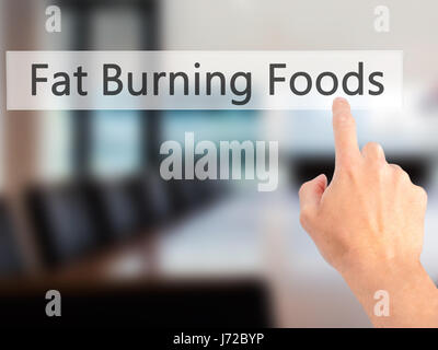 Fat Burning Foods - Mano, premendo un tasto su sfondo sfocato concetto . Business, tecnologia internet concetto. Stock Photo Foto Stock