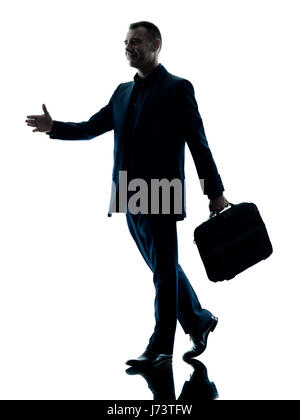 Un caucasian business man walking silhouette isolati su sfondo bianco Foto Stock