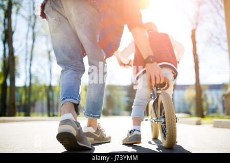 Padre insegna figlio in bicicletta Foto Stock