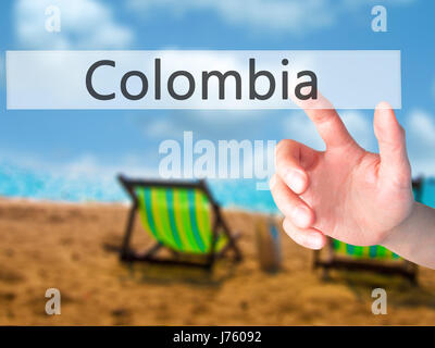 Colombia - Mano premendo un pulsante sul fondo sfocato concetto . Business, tecnologia internet concetto. Stock Photo Foto Stock