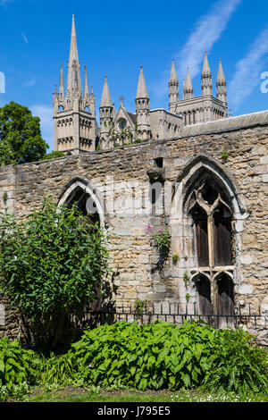 Una vista sulle guglie e torri di Peterborough Cathedral dietro i resti dei monaci dormitorio e Refettorio nella storica città di Peterborough Foto Stock