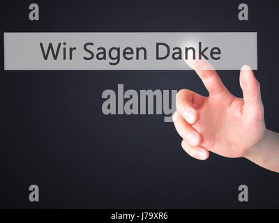 Wir Sagen Danke (Diciamo grazie in tedesco) - Mano premendo un pulsante sul fondo sfocato concetto . Business, tecnologia internet concetto. Stock Ph Foto Stock