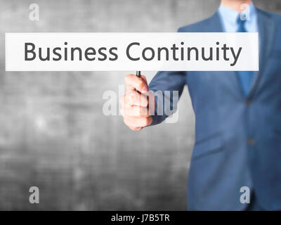 Business Continuity - Business man mostra segno. Business, tecnologia internet concetto. Stock Photo Foto Stock