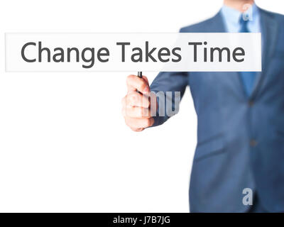 Il cambiamento richiede tempo - Imprenditore mano azienda segno. Business, tecnologia internet concetto. Stock Photo Foto Stock