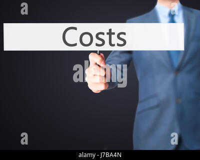 Costi - Business man mostra segno. Business, tecnologia internet concetto. Stock Photo Foto Stock