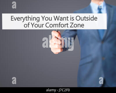 Tutto ciò che si desidera è al di fuori della propria zona di comfort - Imprenditore mano azienda segno. Business, tecnologia internet concetto. Stock Photo Foto Stock