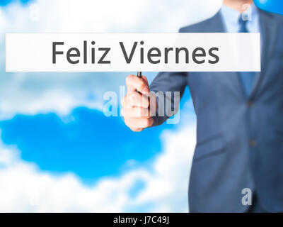 Feliz Viernes (Venerdì felice in spagnolo) - Imprenditore mano azienda segno. Business, tecnologia internet concetto. Stock Photo Foto Stock