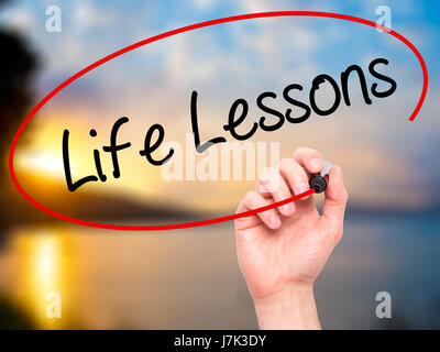 Man mano che scrive le lezioni di vita con pennarello nero su schermo visivo. Isolato sulla natura. Business, tecnologia internet concetto. Stock Photo Foto Stock