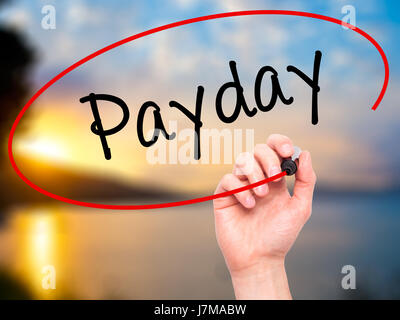 Man mano che scrive Payday con pennarello nero su schermo visivo. Isolato sulla natura. Business, tecnologia internet concetto. Stock Photo Foto Stock