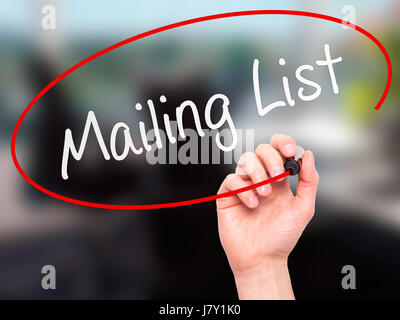 Man mano che scrive Mailing List con marcatore sul panno trasparente stampato. Isolato su office. Business, internet, concetto tecnologico. Stock Photo Foto Stock