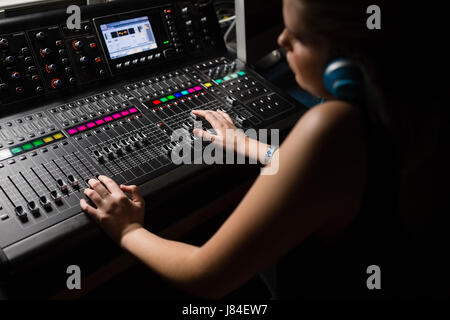 Femmina ingegnere audio con mixer audio in studio di registrazione Foto Stock