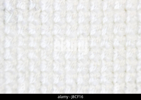 Macro shot frammento pattern ricamo filo bianco ricamo a mano, pattern in cross-stitch stile su tessuto bianco. Foto Stock