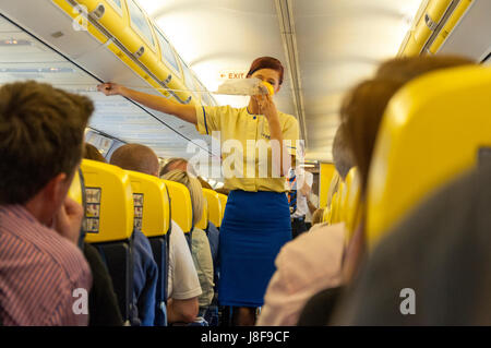 Volo di dimostrazione di sicurezza a bordo di un volo Ryanair. Attendant dimostra le maschere di ossigeno Foto Stock