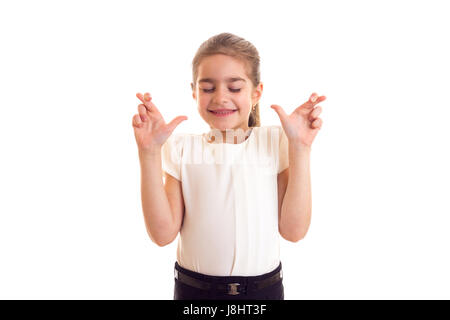 Bambina in T-shirt bianco e gonna nera dita incrociate Foto Stock