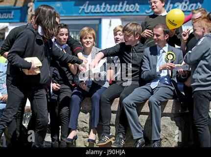 Primo Ministro Nicola storione e il SNP candidato locale Stephen Gethins chip di condividere con i bambini delle scuole su una campagna elettorale visita a Anstruther, Fife. Foto Stock