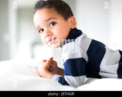 Ritratto di ragazzo (2-3) giacente sul letto Foto Stock