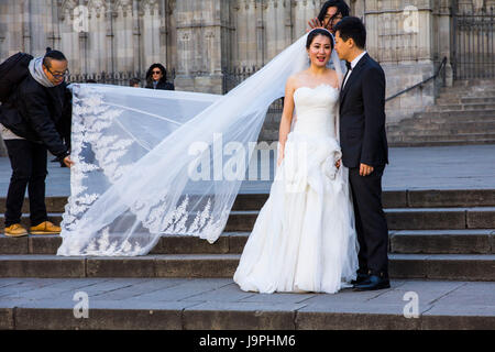 Un asiatico giovane pone per foto di nozze di fronte la Cattedrale di Barcelona, Barcelona, Spagna. Foto Stock