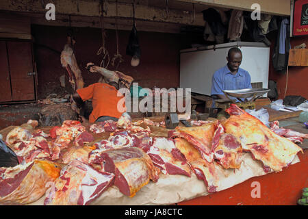 KAMPALA, UGANDA - Settembre 29 2012. Due uomini africani il lavoro e preparare la carne in una sporca mercato all'aperto a Kampala in Uganda nel settembre 28,2012. Foto Stock