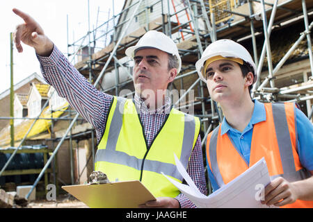 Architetto in loco per discutere i piani con Builder Foto Stock
