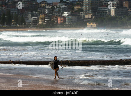 Surfisti a Manly Beach in un giorno di tempesta. Periferia nord di Sydney, NSW, Australia. Foto Stock