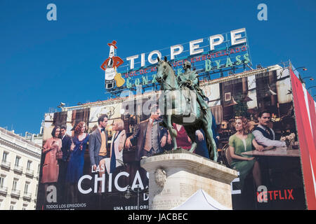 Vecchia cultura incontra di nuovo. Statua equestre di re Carlo III accanto alla pubblicità moderna pensione in Puerta Del Sol di Madrid, Spagna. Foto Stock