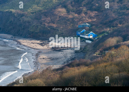 Alta Vista su Runswick Bay Beach e la Vela Club clubhouse, accoccolato sotto le scogliere & sulla spiaggia, vicino al mare - North Yorkshire, Inghilterra, Regno Unito. Foto Stock