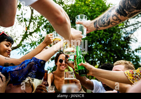 Gruppo di diversi amici celebrando bere birre insieme Foto Stock