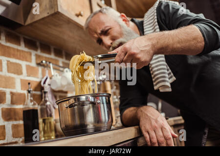 L'uomo cucinare gli spaghetti Foto Stock