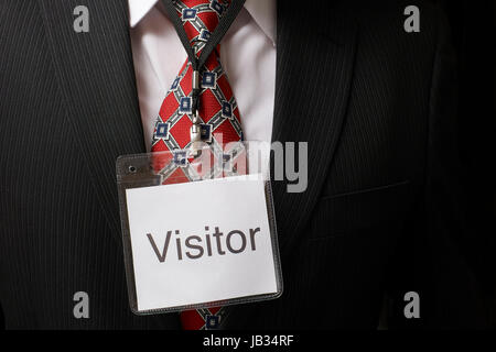 Imprenditore indossando un visitatore distintivo di identificazione intorno al suo collo Foto Stock