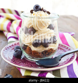 Cremiges Dessert in Schichten mit frischen Blaubeeren Foto Stock