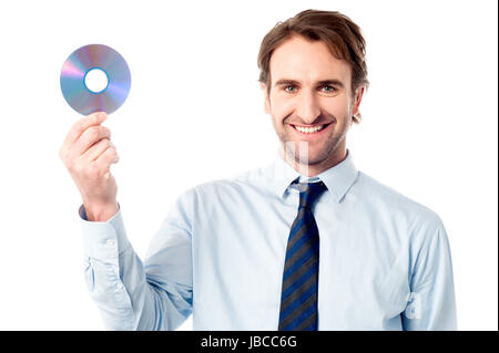 Smart executive tenendo un compact disc Foto Stock