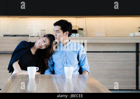 Asian Bella coppia Giovane seduto in un bar, a bere caffè e godendo la conversazione. Coppia romantica risalente al cafe'. Amore e tenerezza Foto Stock