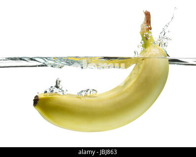 Banana schizzi in acqua chiara isolato su bianco. Foto Stock