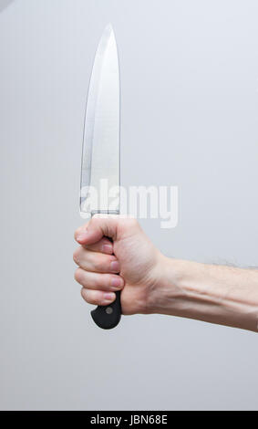 Primo piano di man mano che tiene il coltello di grandi dimensioni Foto Stock