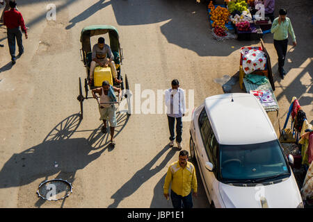 Vista aerea su un uomo tira un rickshaw su una strada nel quartiere nuovo mercato Foto Stock