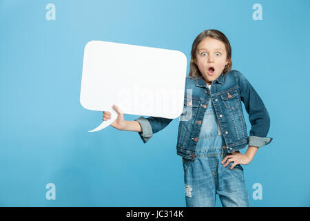 Scioccato bambina azienda vuoto discorso bolla su blu Foto Stock