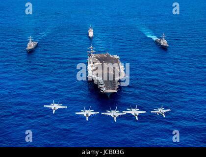 Stati Uniti Navy F/A-18 Hornets e Super calabroni da Carrier aria Wing due volare davanti alla Nimitz-class portaerei USS Carl Vinson scortato dai Arleigh Burke-class guidato-missile cacciatorpediniere USS Wayne E. Meyer, destra, USS Michael Murphy, sinistra e Ticonderoga-class guidato-missili cruiser USS Lake Champlain Giugno 12, 2017 nell'Oceano Pacifico. Foto Stock