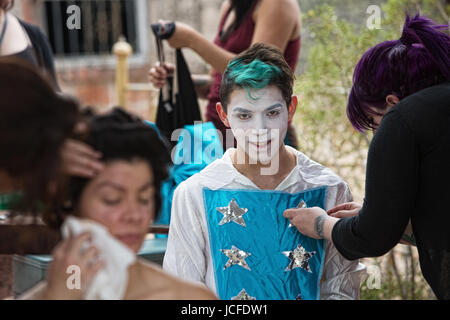 Trucco artisti medicazione clown con i capelli verdi e maglietta a stella Foto Stock