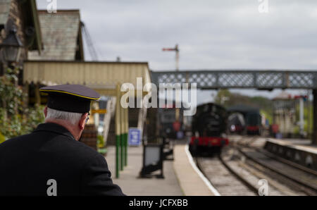 Embsay e Bolton Abbey Railway motore a vapore patrimonio turistico stazione treno arriva Soft Focus con stazione di volontariato Master una messa a fuoco nitida in primo piano Foto Stock