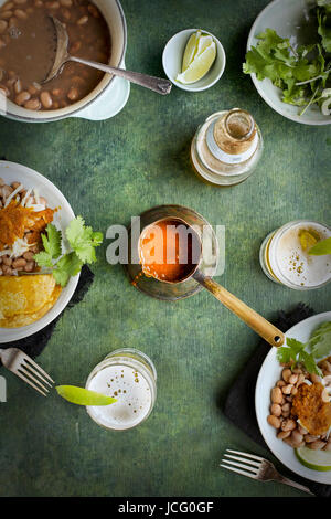 Salsa Ranchero in un vintage siviera di rame. Fotografato su uno sfondo verde. Foto Stock